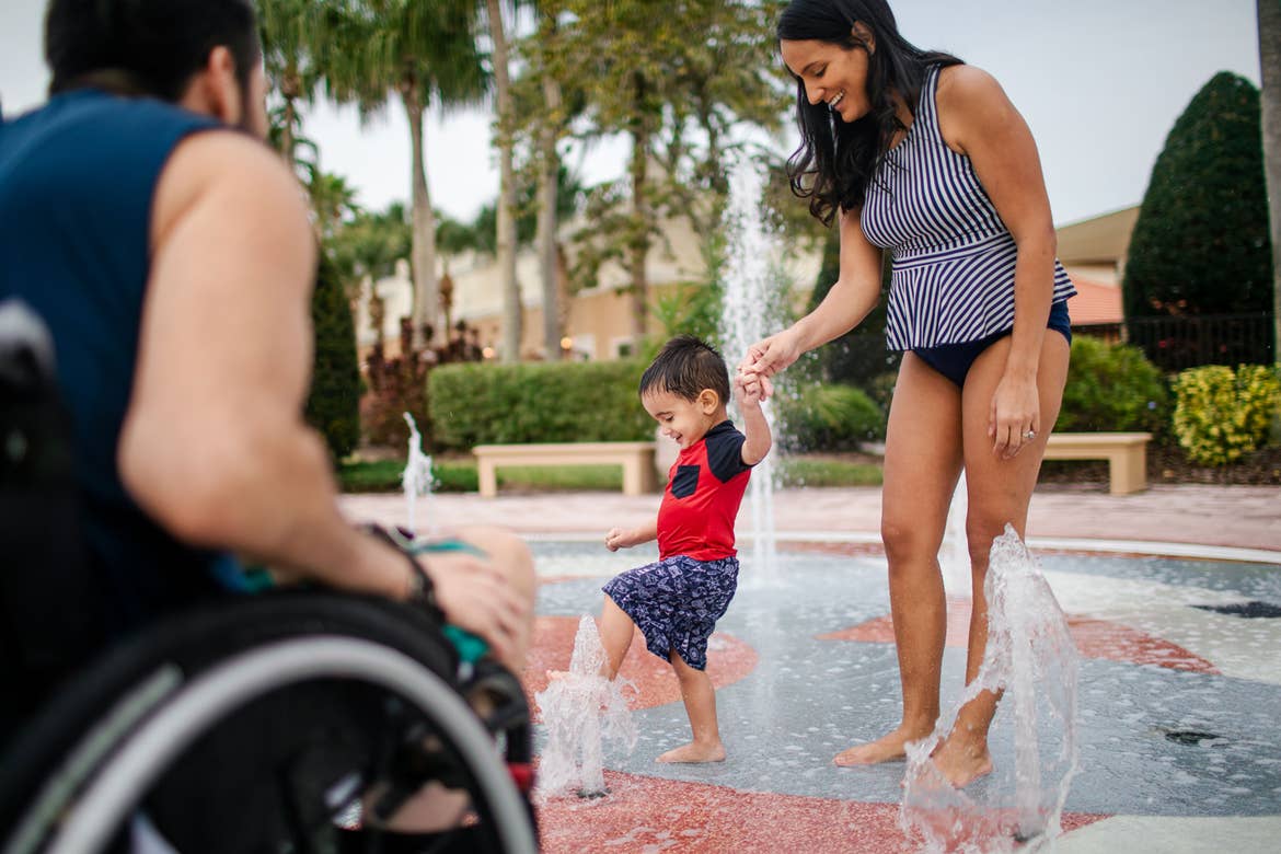 Author, Danny Pitaluga (left), his wife, Val (right) and son, Joey (middle), wear their swimsuits near a fountain park area at our Orange Lake Resort located in Orlando, Florida.