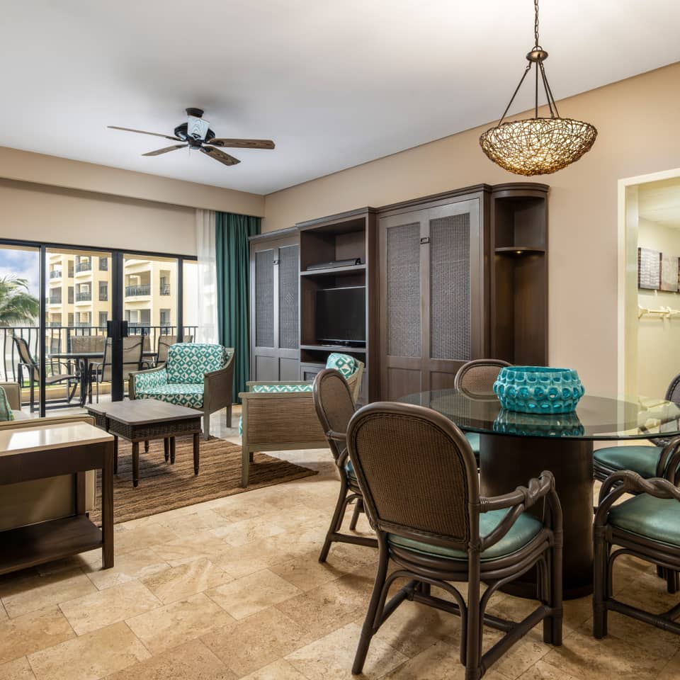 Bright oceanview living room with a dining area and balcony.
