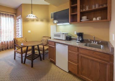 Kitchenette with microwave and mini-fridge and small dining area in a studio room at David Walley's Resort in Genoa, Nevada
