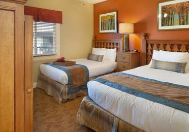 Bedroom with two beds in a villa at Smoky Mountain Resort in Gatlinburg, Tennessee.
