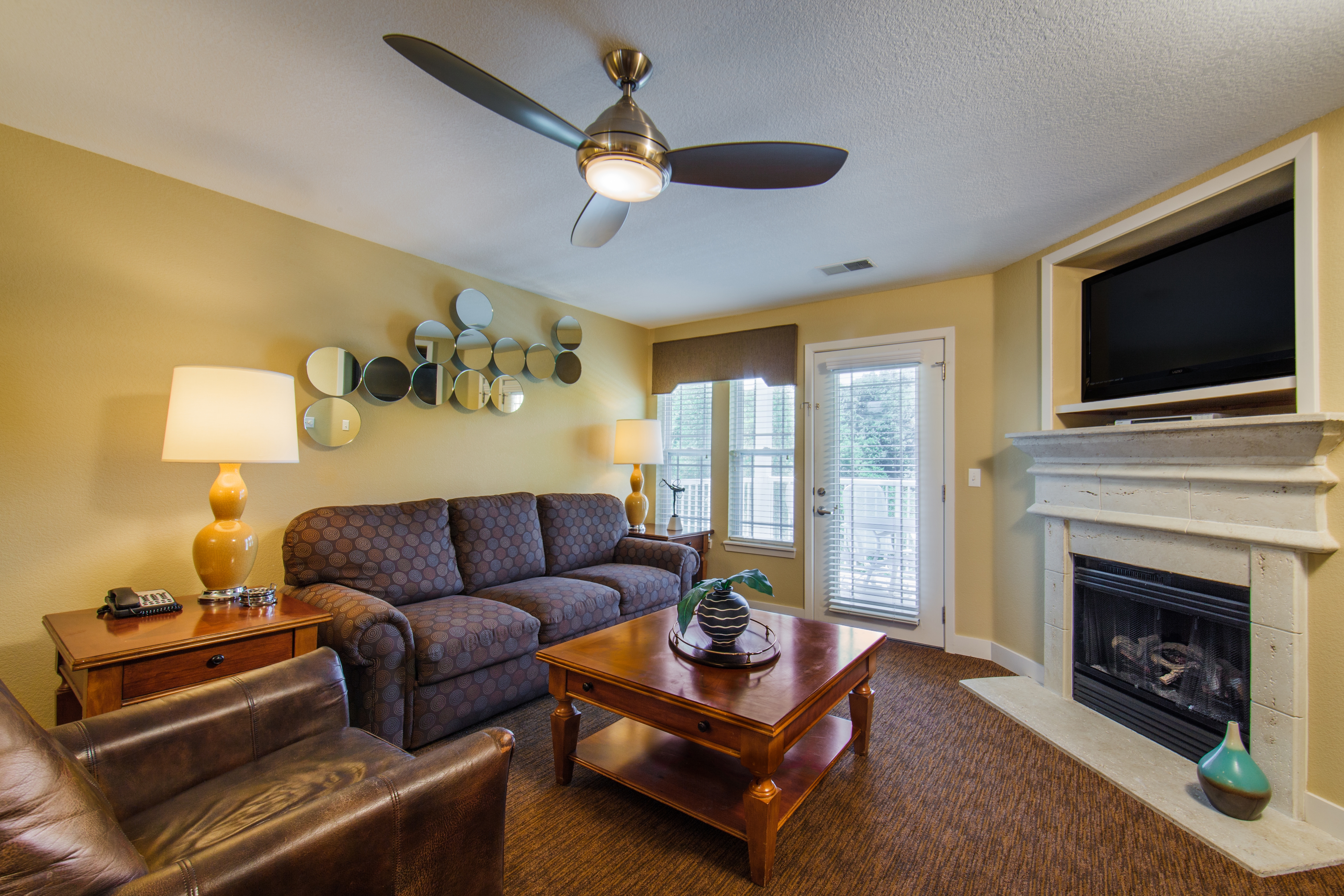 Living room with fireplace in a two-bedroom ambassador villa at the Holiday Hills Resort in Branson Missouri.