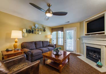 Living room with fireplace in a two-bedroom ambassador villa at the Holiday Hills Resort in Branson Missouri.