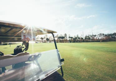 Golf cart driving on golf course in West Village at Orange Lake Resort near Orlando, Florida