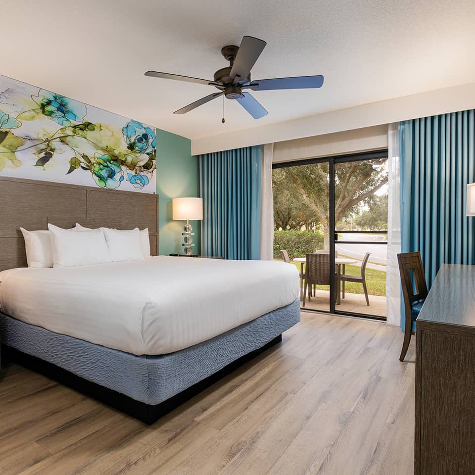 An inviting bedroom with a king bed and patio space.