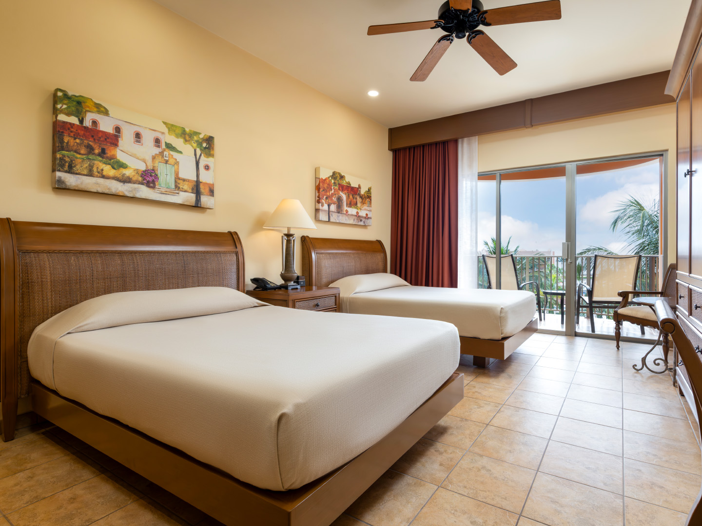 Oceanview bedroom with balcony and two comfortable beds.