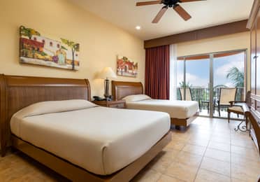 Oceanview bedroom with balcony and two comfortable beds.