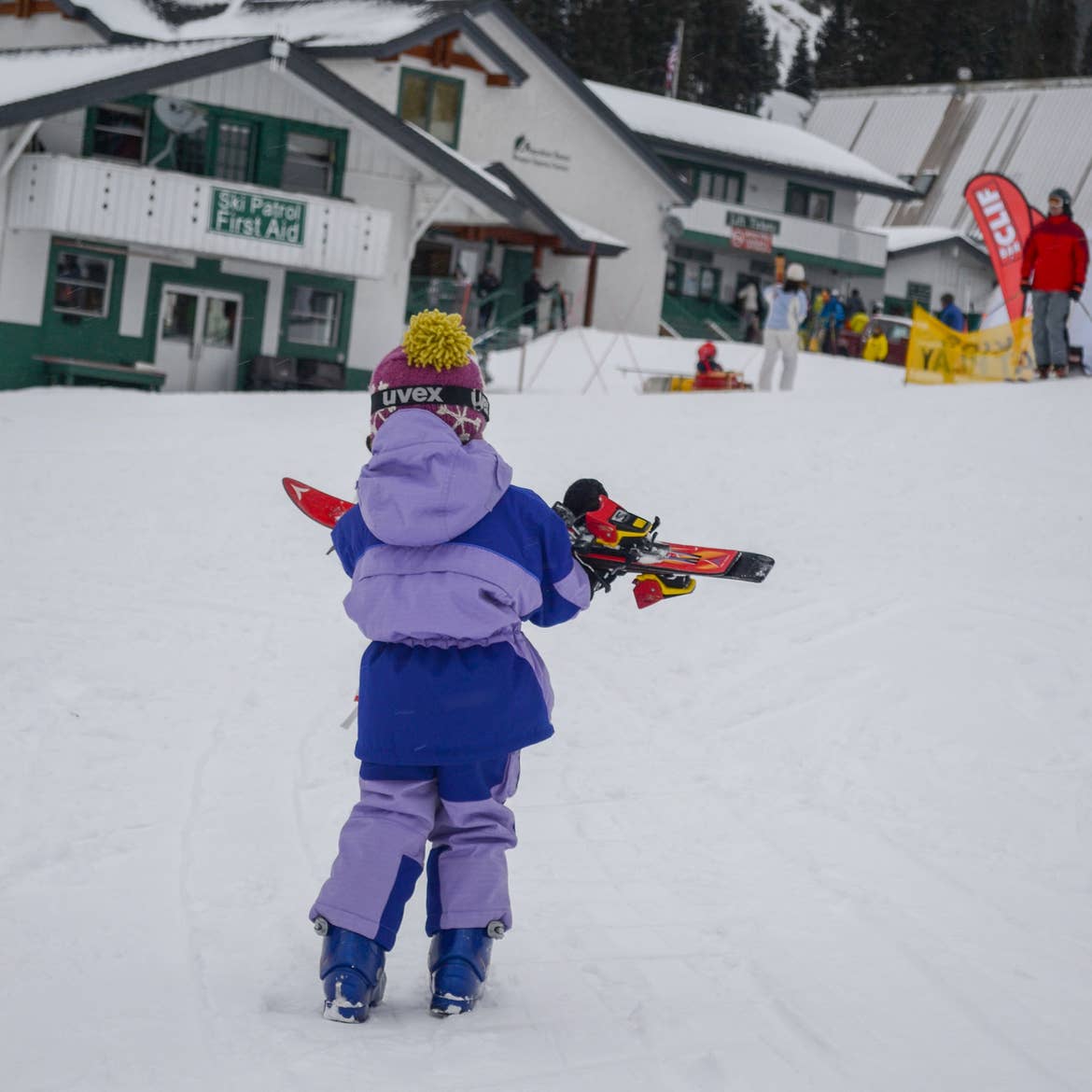 Jessica's daughter carries her skis to the slopes.