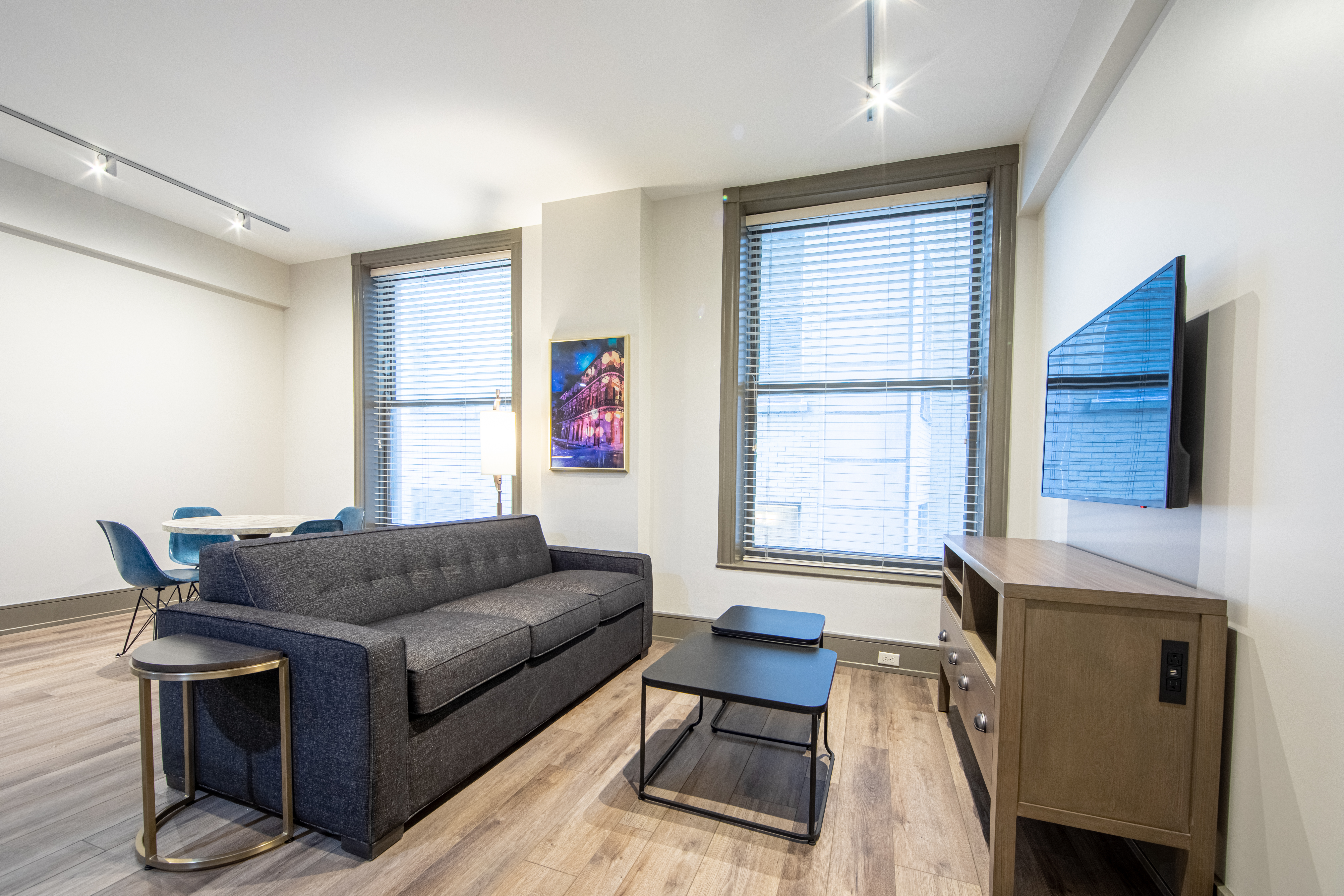 Two bedroom villa living area with couch, two windows and TV at New Orleans Resort in Louisiana.