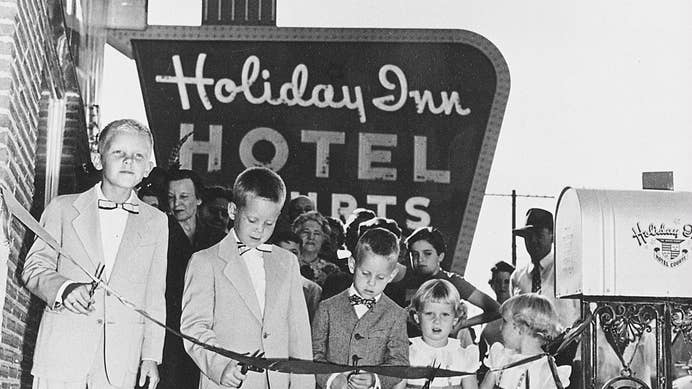 Kemmons Wilson cutting a ribbon at the first Holiday Inn with his family