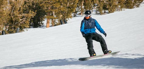 Guest snowboarding down mountain near Tahoe Ridge Resort in Stateline, Nevada.