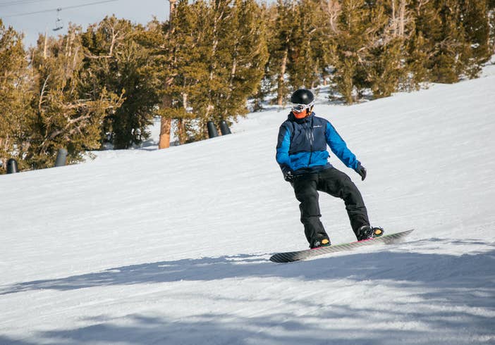 Guest snowboarding down mountain near Tahoe Ridge Resort in Stateline, Nevada.