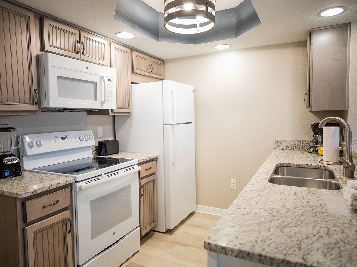 Full kitchen with fridge, oven and microwave in a villa at Cape Canaveral Beach Resort.