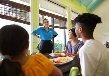 Family speaking to waitress in restaurant at Orange Lake Resort near Orlando, Florida