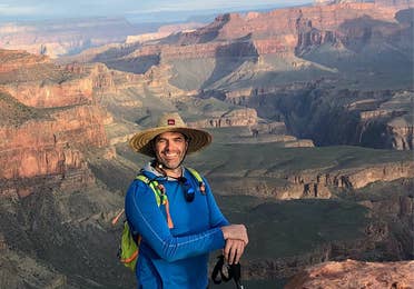 Man standing in front of Grand Canyon near Scottsdale Resort.