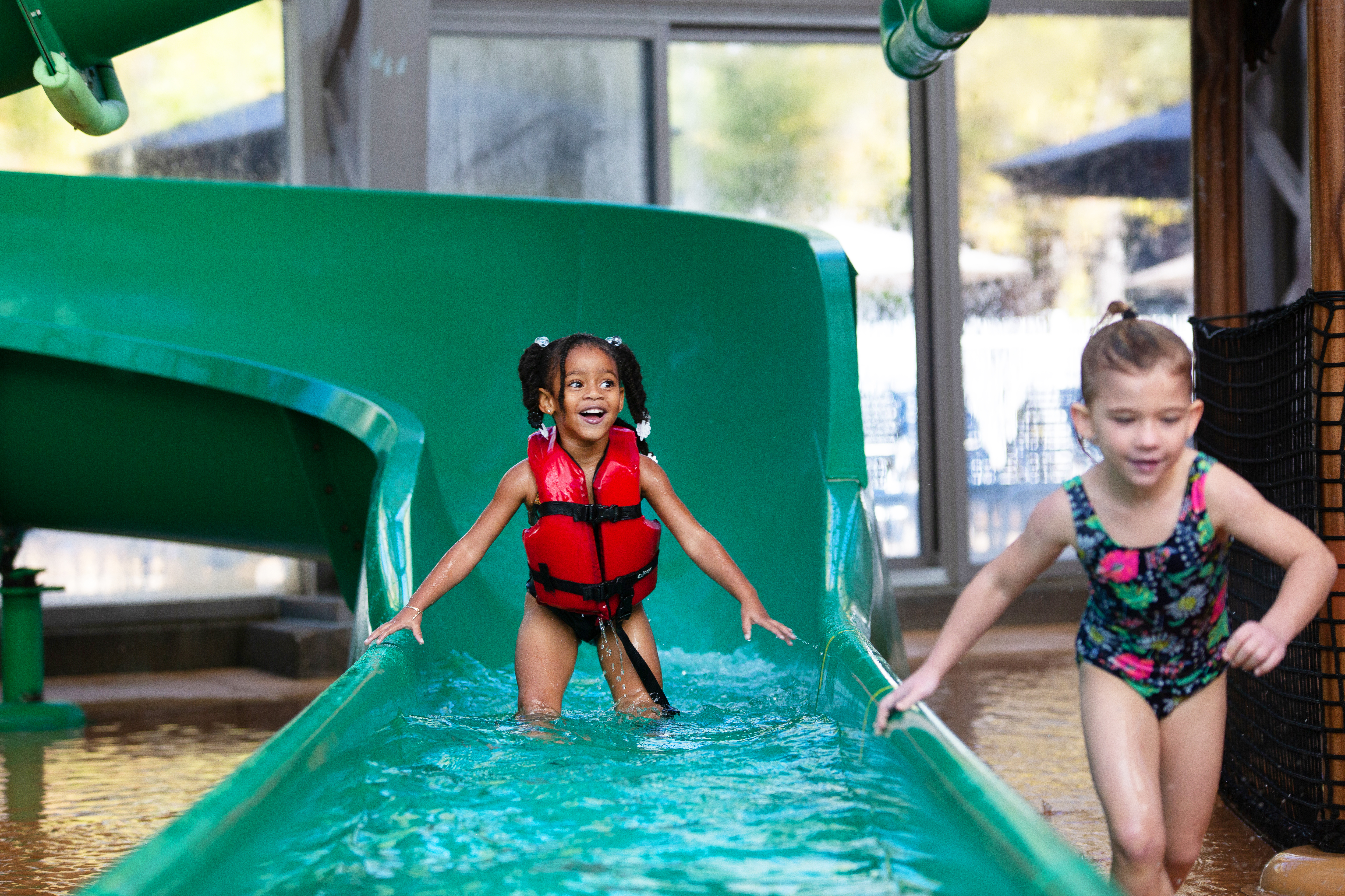 Two toddlers coming off of a waterslide at the Waterpark at the Villages