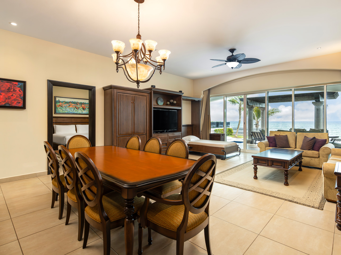 Suite living room with dining area, Murphy bed, and ocean views.