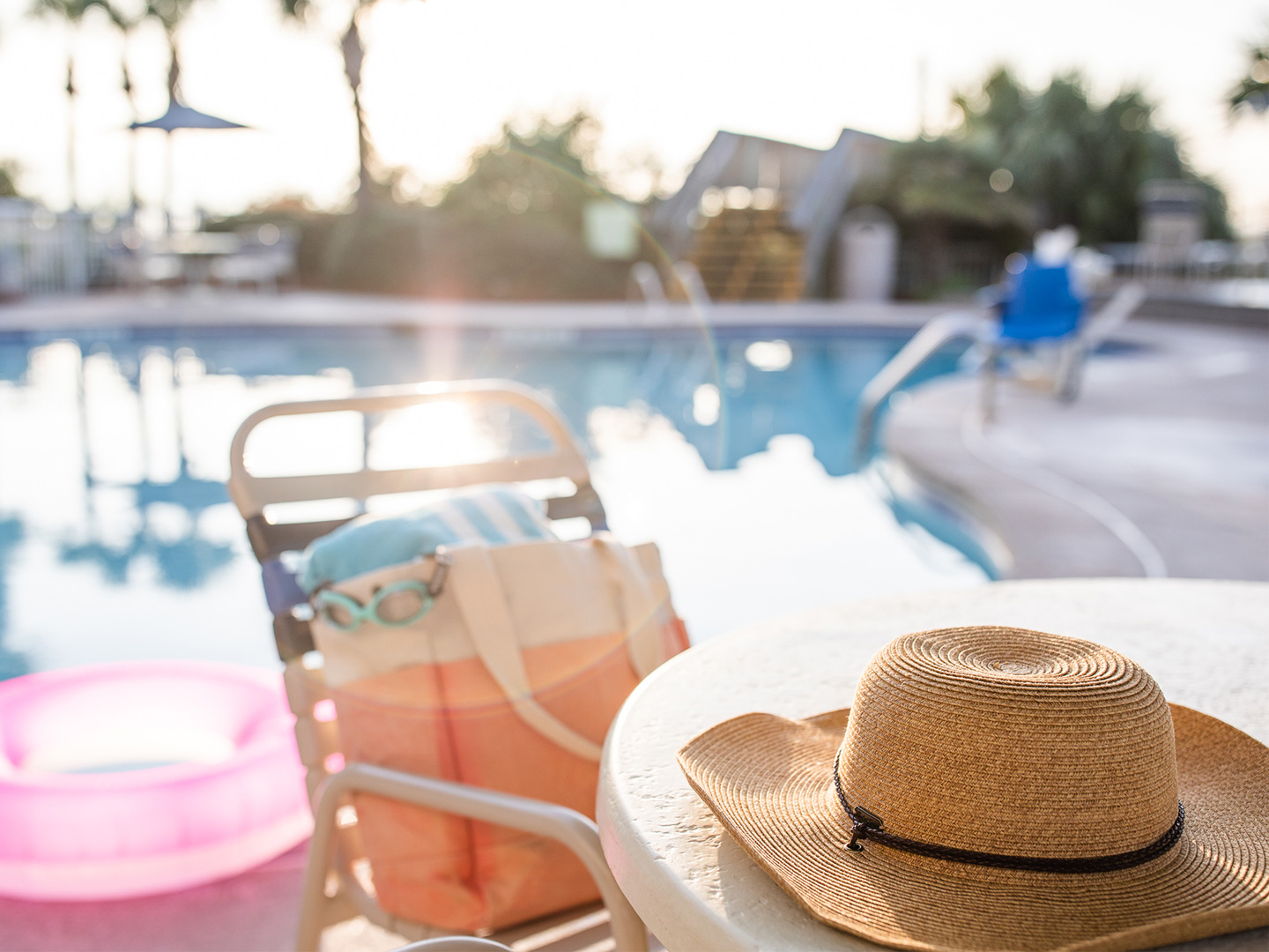 Jennifer's hat sits on a table with swimwear next to the poolside of a Holiday Inn Club Vacation Resort.