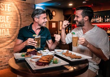 Two men having dinner and beers at The Royal Cancun in Mexico.