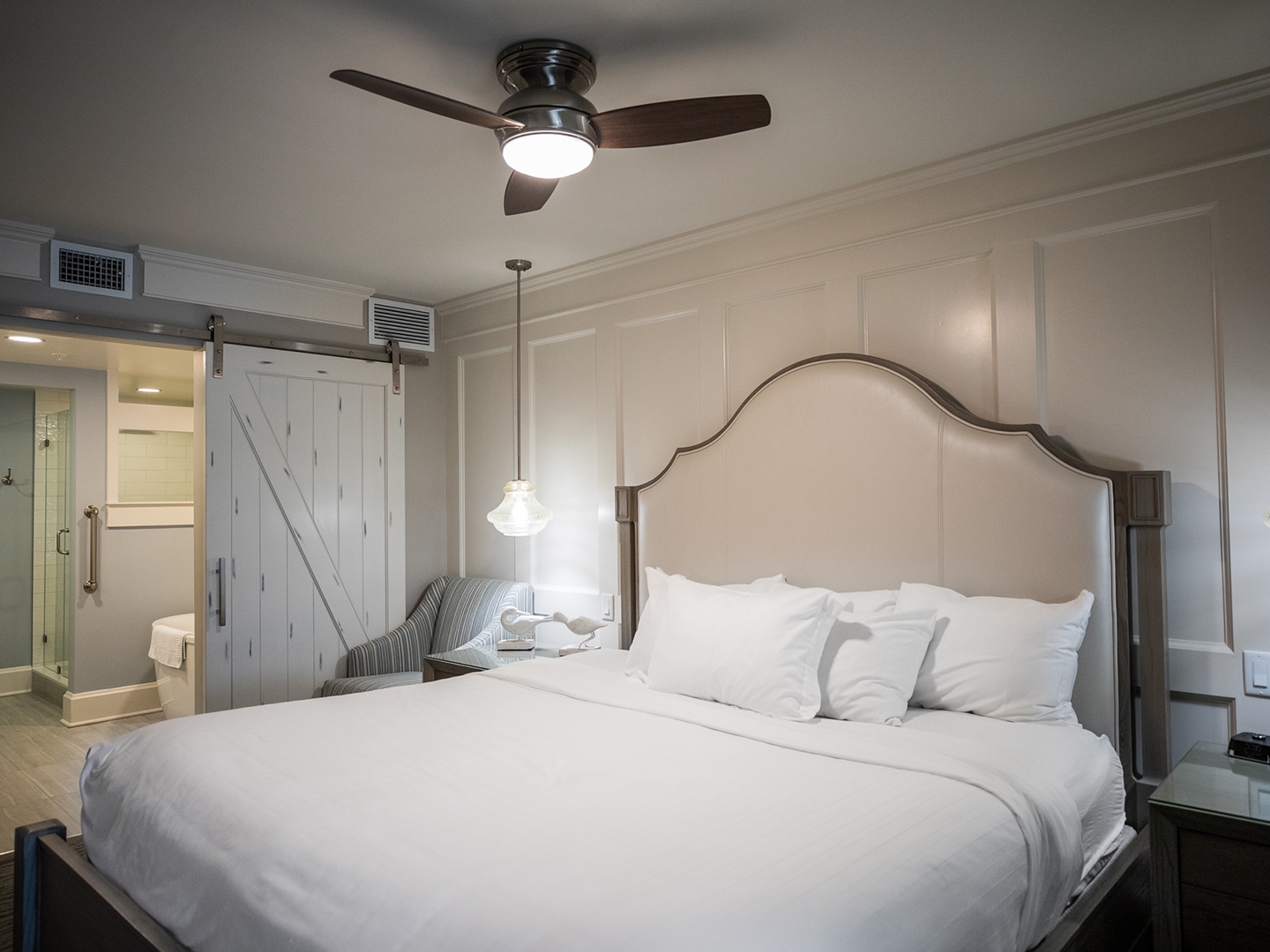 Bedroom with bed and ceiling fan in a two-bedroom Signature Collection villa at Cape Canaveral Beach Resort.