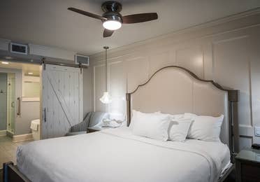 Bedroom with bed and ceiling fan in a two-bedroom Signature Collection villa at Cape Canaveral Beach Resort.