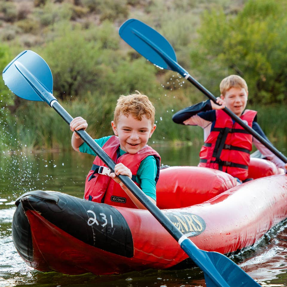 Two young children kayaking near Scottsdale Resort.
