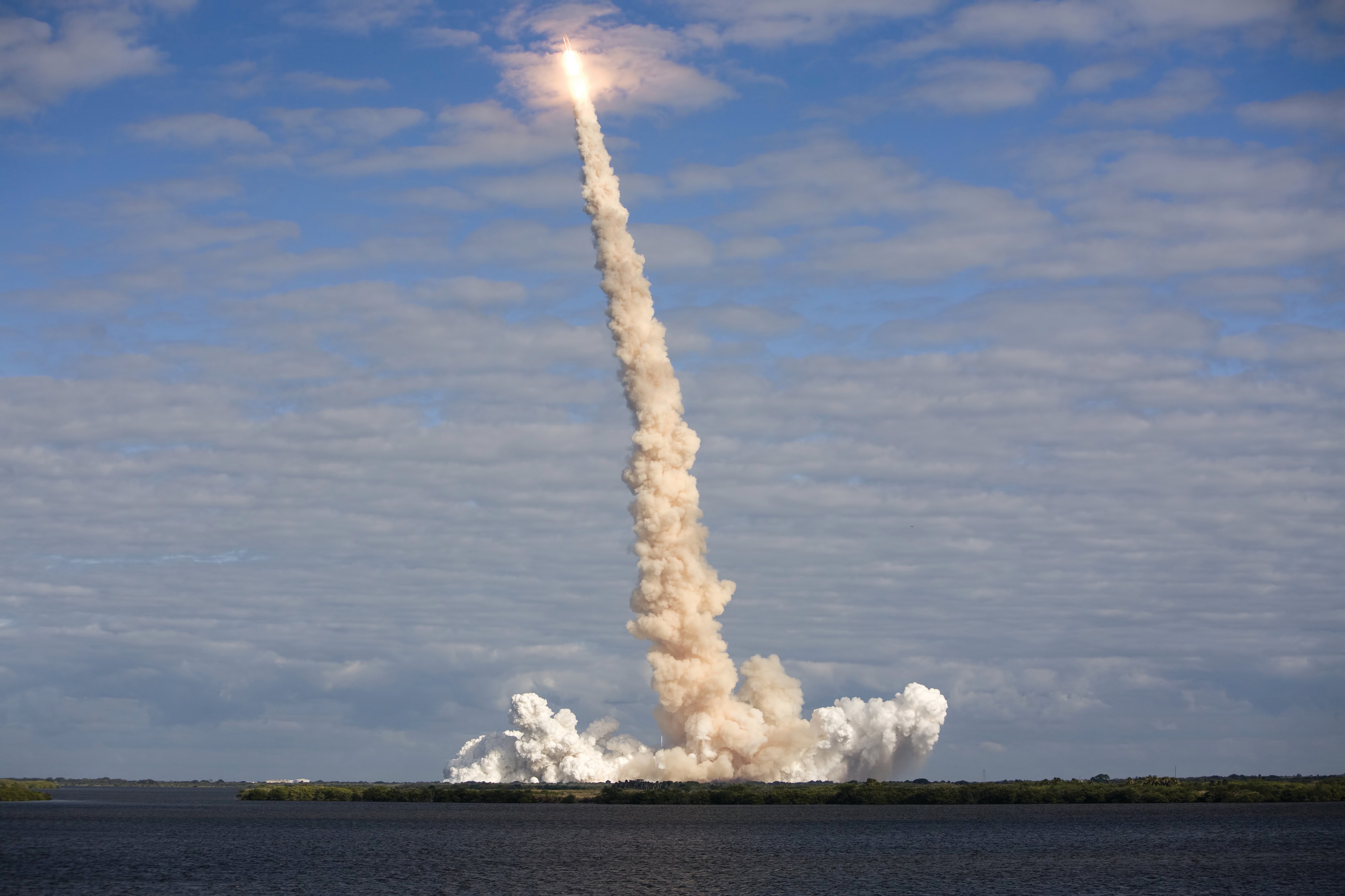 A trail of clouds from a rocket shooting into the atmosphere