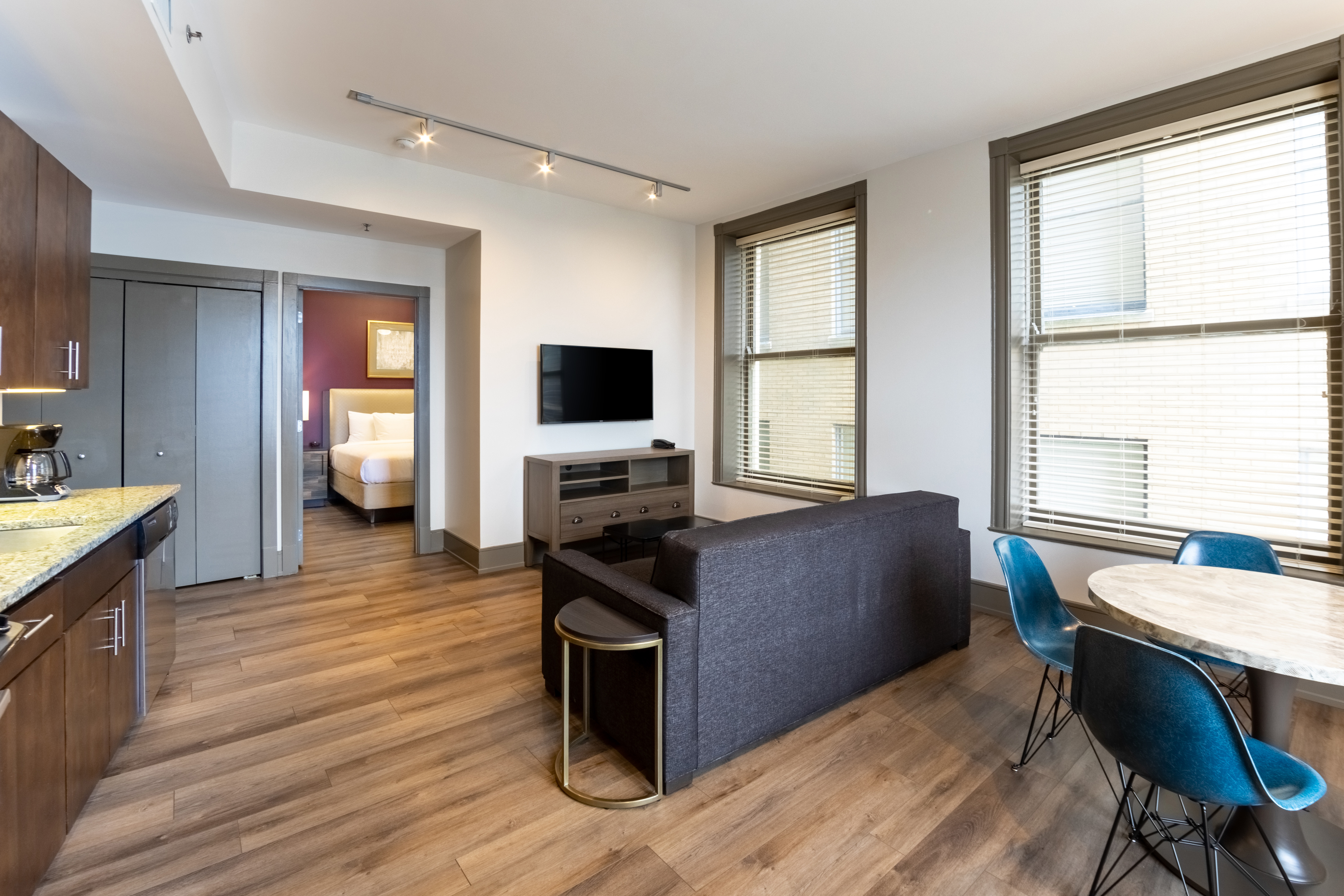 One bedroom villa living room with dining area, couch and TV at New Orleans Resort in Louisiana.