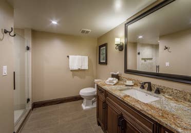 Bathroom with single vanity, toilet, and walk-in shower in a Two-Bedroom Signature Collection villa at Scottsdale Resort in Arizona