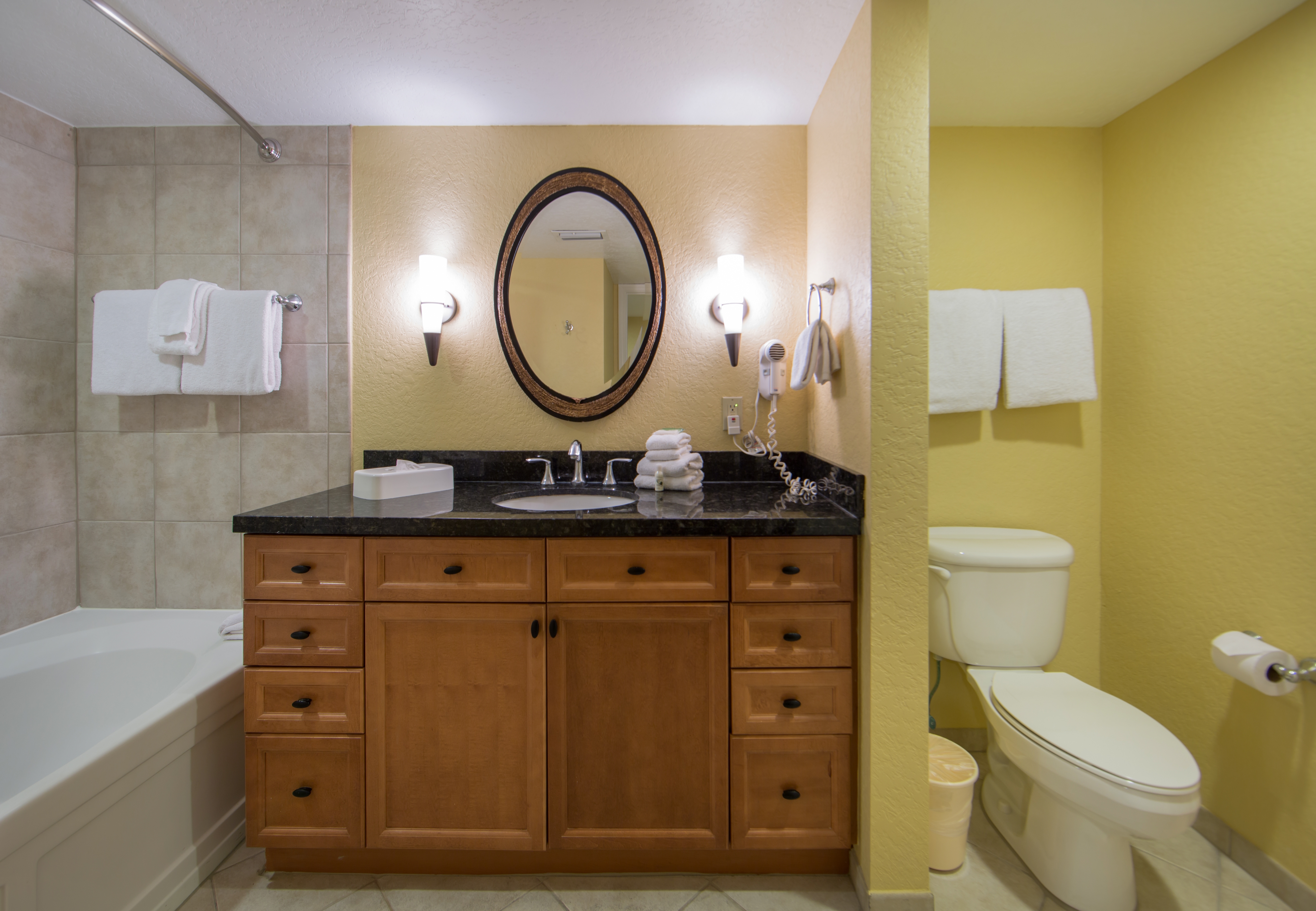 Bathroom with shower/tub combination and sink with mirror in a one bedroom villa in West Village at Orange Lake Resort near Orlando, FL