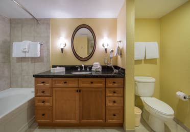 Bathroom with shower/tub combination and sink with mirror in a one bedroom villa in West Village at Orange Lake Resort near Orlando, FL