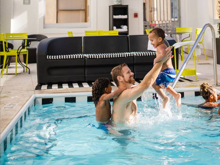 Family playing in a pool at Holiday Inn Club Vacations New Orleans Resort.
