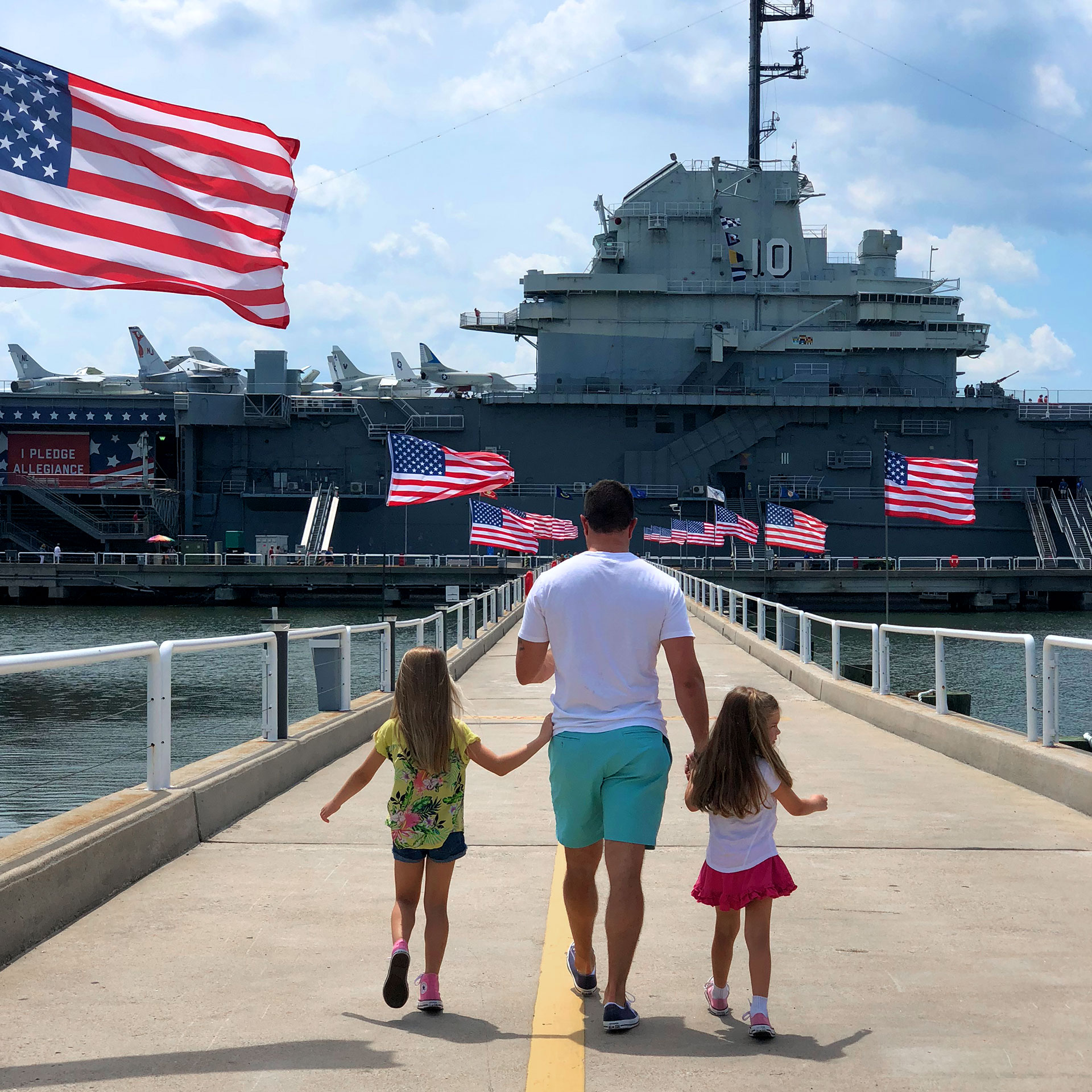 Author, Chris Johnstons' husband, Josh (middle), walks towards the USS Yorktown CV-10 Museum in Charleston with their daughters Kyndall (left) and Kyler (right).