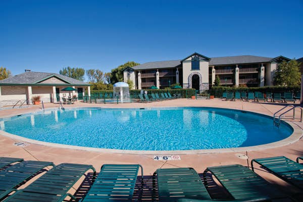 Outdoor pool with beach chairs at Lake Geneva Resort