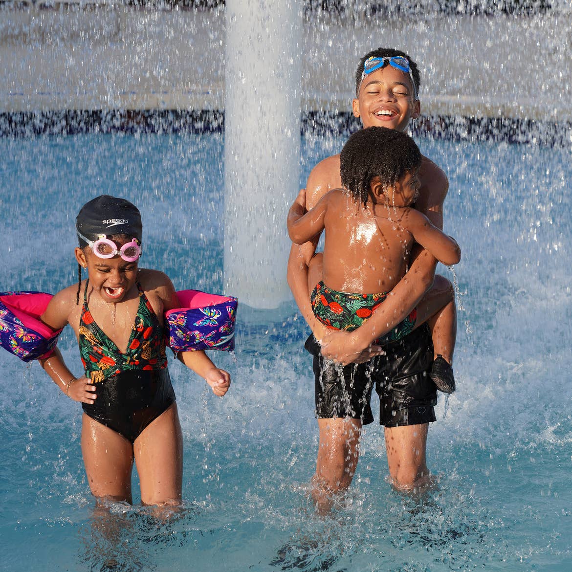 Featured Contributor, Tina Meeks' children stand in the splash pool of our Orange Lake resort in Orlando, Florida.