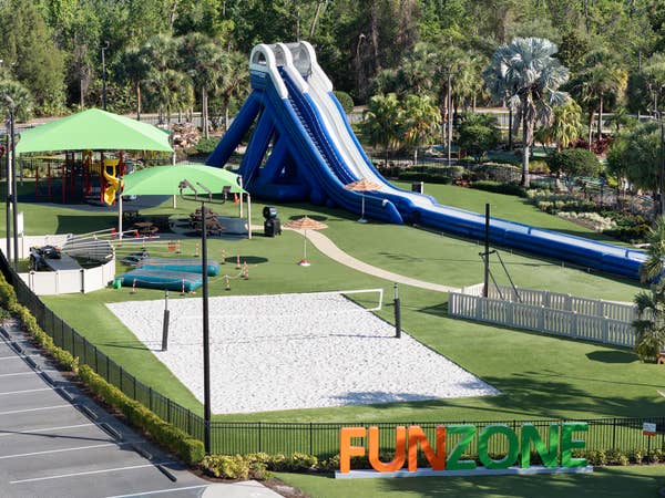 Fun Zone at Orange Lake Resort in Orlando, FL showing an inflatable slide and beach volleyball court.