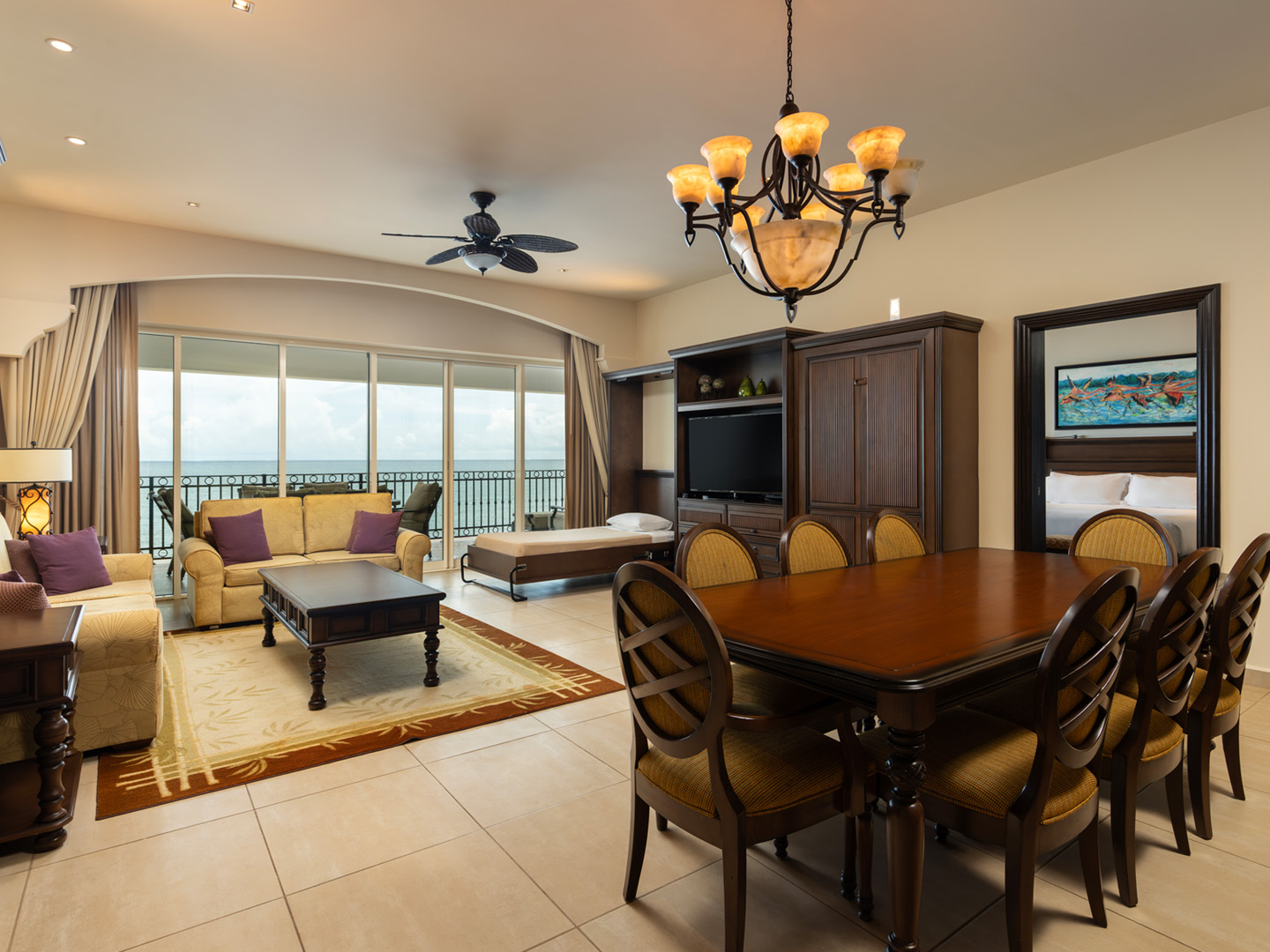 Ocean-facing suite with dining area, daybed, and balcony.