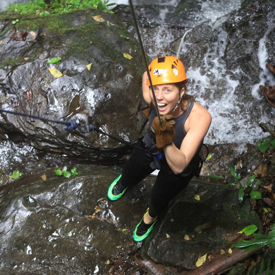 Featured contributor, Tiffany smiles after rappelling down a waterfall in Costa Rica.