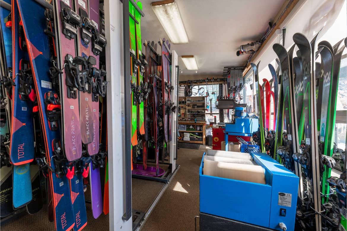Multiple sets of skis in a rental shop.