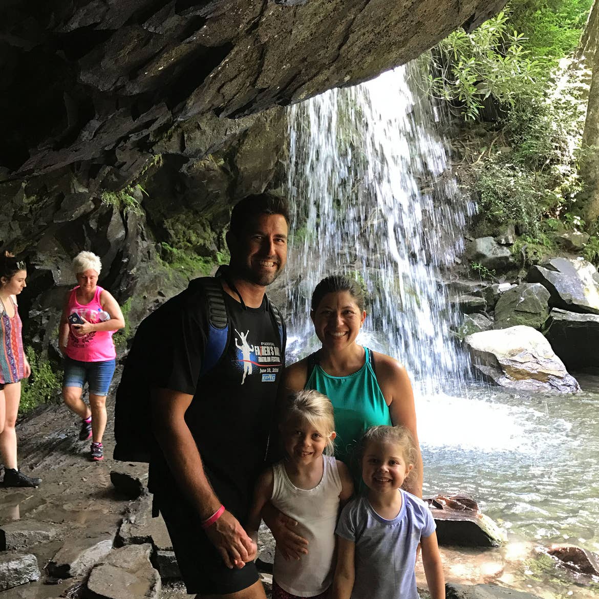 Author, Chris Johnston (back-right), stands near the Grotto Falls of the Mammoth Cave National Park with her husband, Josh (back-left), and daughters, Kyndall (front-left), and Kyler (front-right).