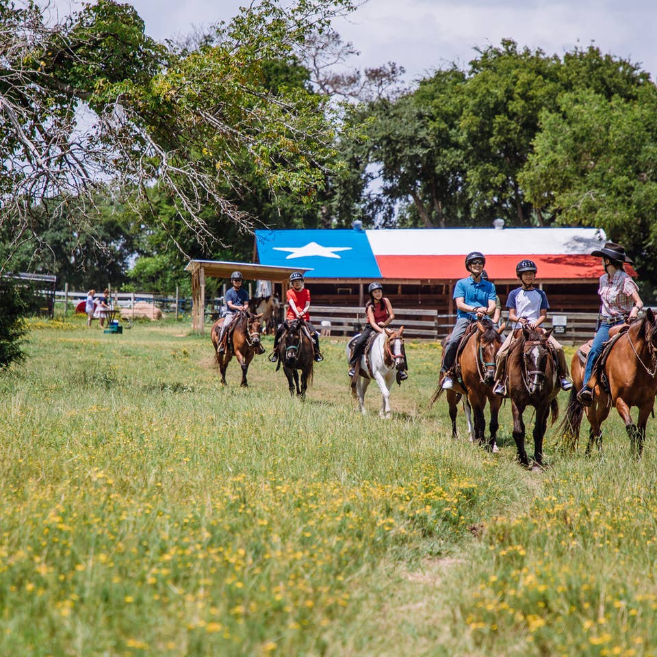 Guests riding horses at Villages Resort in Flint, Texas.
