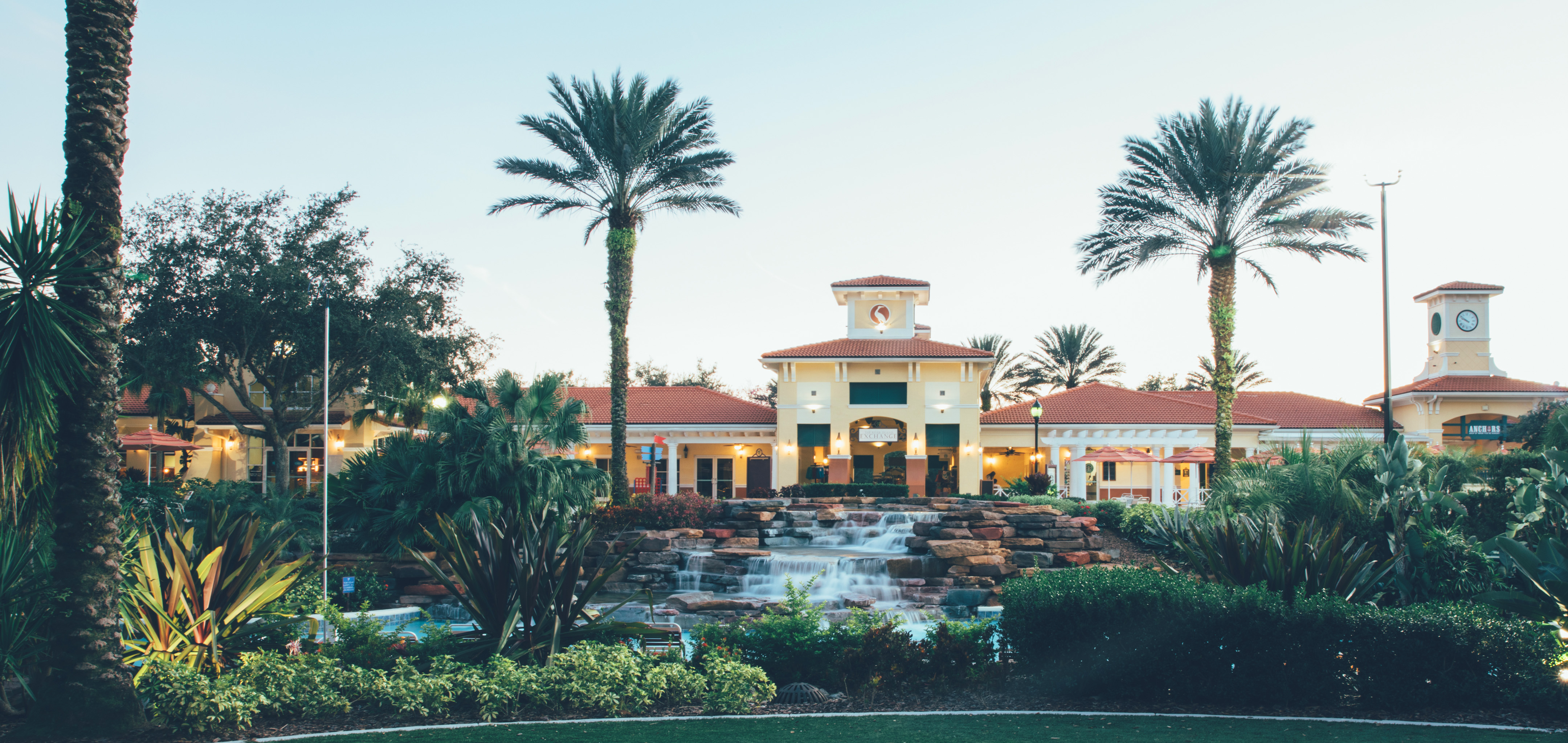 View of lazy river and The Exchange at night in River Island at Orange Lake Resort near Orlando, Florida