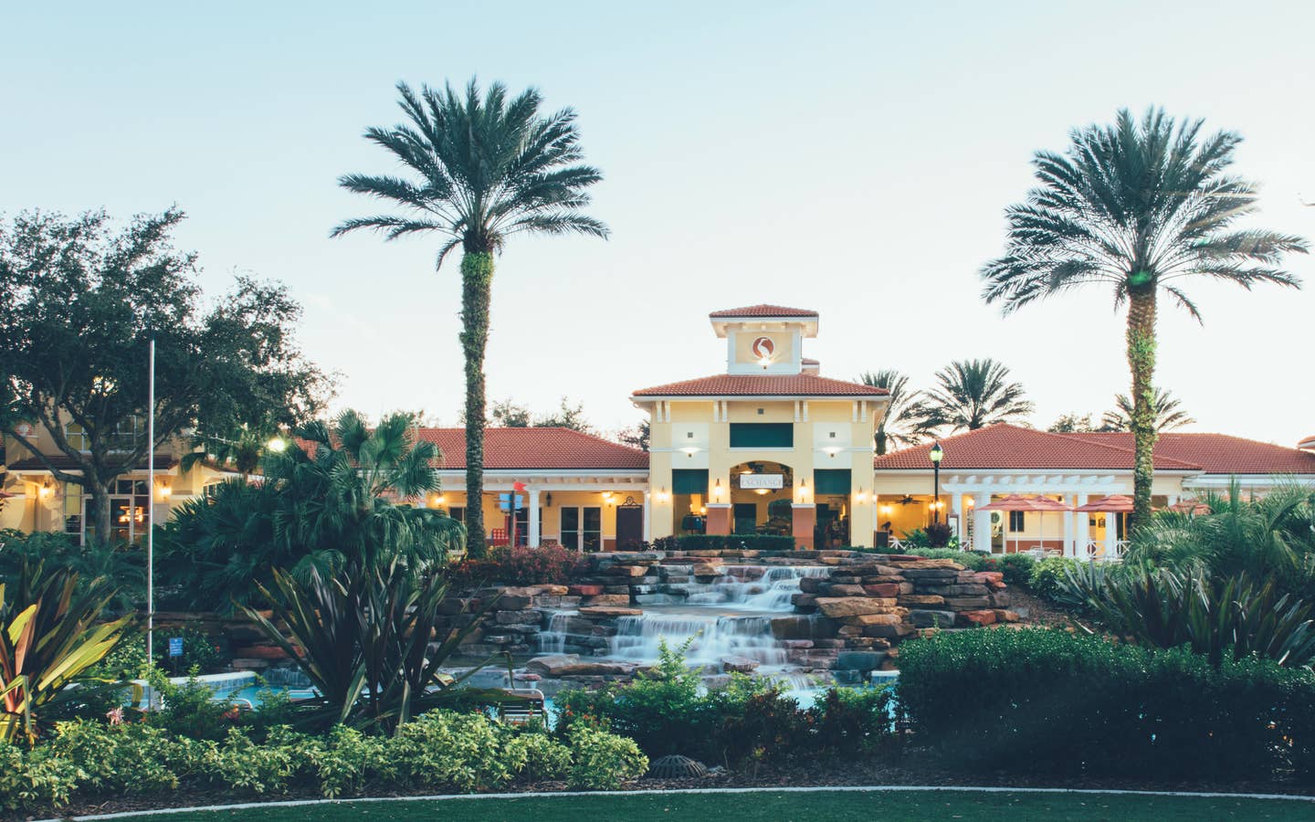 View of lazy river and The Exchange at night in River Island at Orange Lake Resort near Orlando, Florida