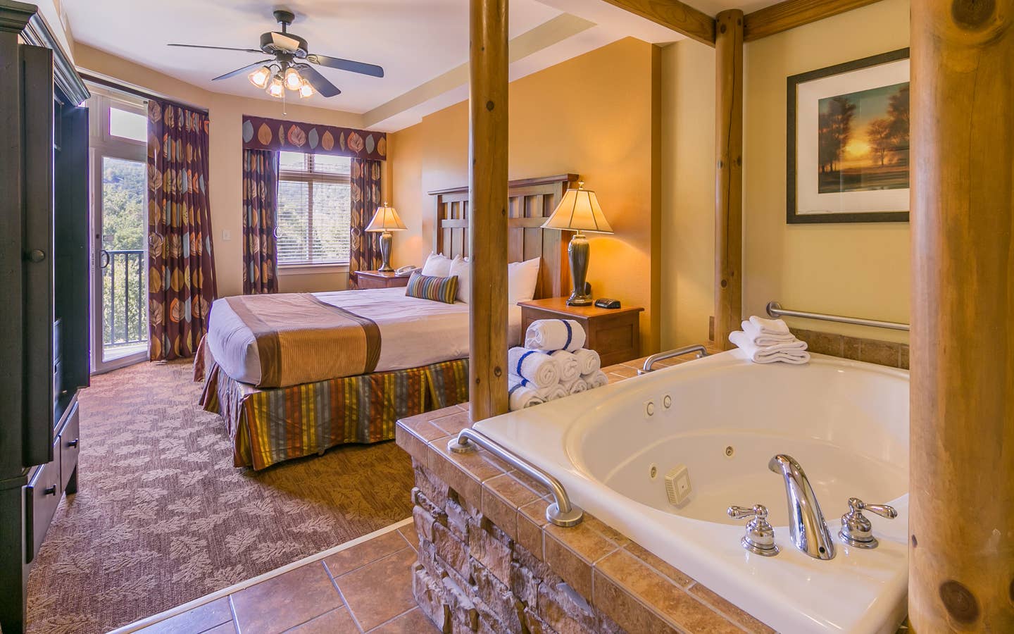 Bedroom with a bed and jacuzzi tub at Smoky Mountain Resort in Gatlinburg, Tennessee.