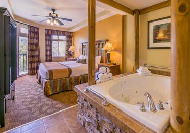 Bedroom with a bed and jacuzzi tub at Smoky Mountain Resort in Gatlinburg, Tennessee.