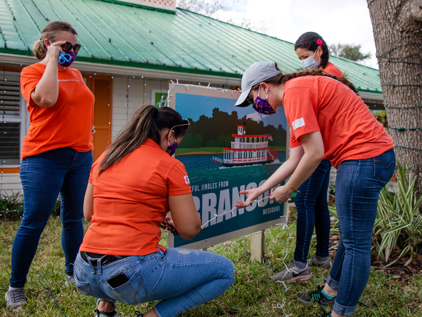 HICV Team Member help setup the festive decor outside of their Villa at Give Kids the World.