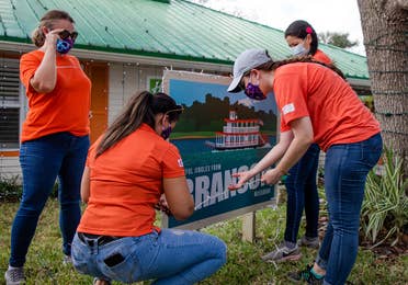 HICV Team Member help setup the festive decor outside of their Villa at Give Kids the World.