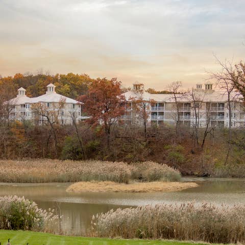 Outdoor view of property buildings surrounded by fall foliage at Fox River Resort in Sheridan, Illinois