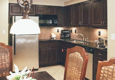 Full kitchen with stainless steel appliances in a Signature villa in River Island at Orange Lake Resort near Orlando, Florida