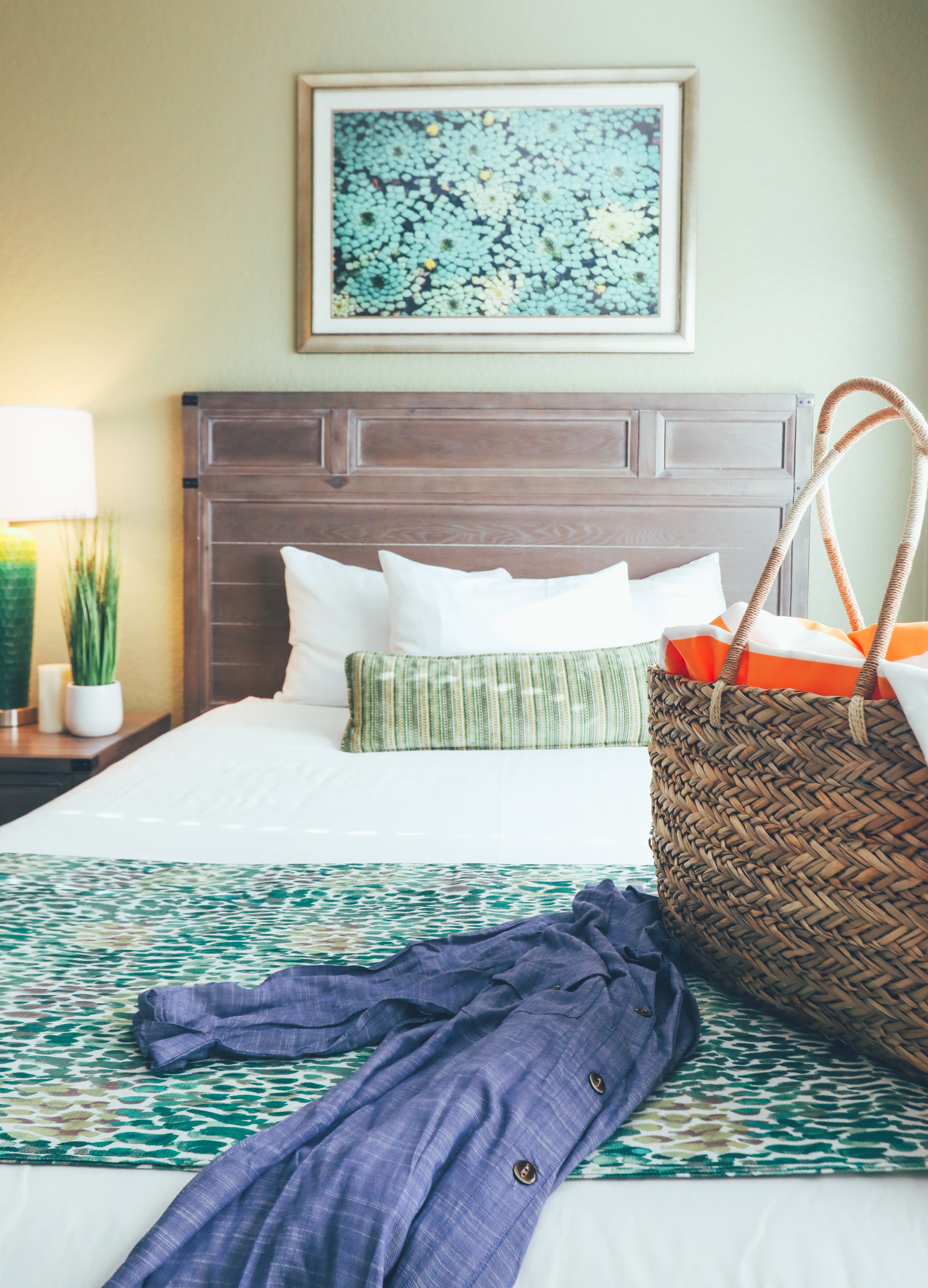 Bed with beach bag on covers in a villa in River Island at Orange Lake Resort near Orlando, Florida