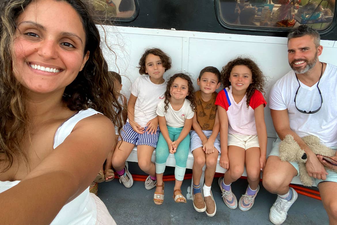 Author, Brenda Rivera Sterns (left) and family sit outside of a Dolphin Cruise ship on the pier.